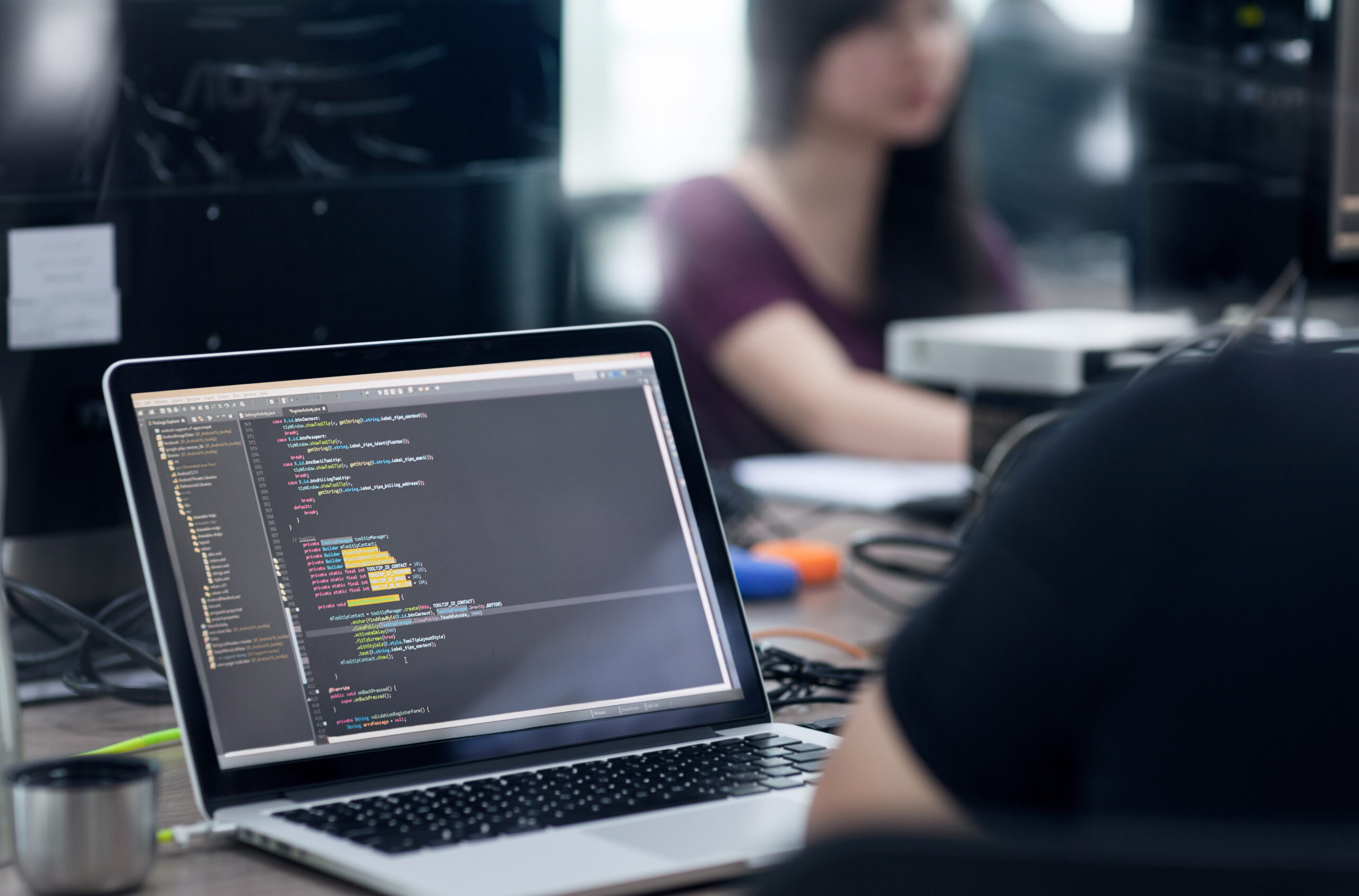 Developer writing application code on a laptop